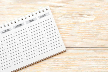 Obraz premium empty week planner on white office table, week end concept