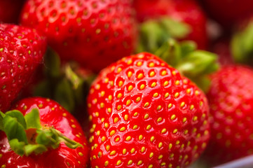 fresh ripe strawberries on black ceramic plate