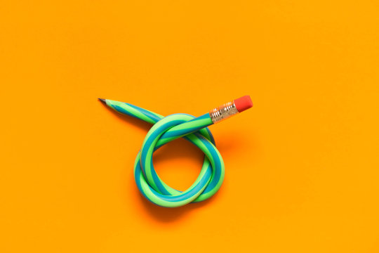  Flexible pencil . Isolated on orange background