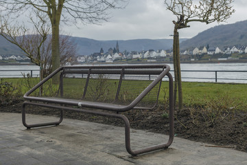 modern iron bench close-up in the recreation area on the banks of the Rhine