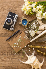 Rustic wedding planning and photography concept. Notepad, seashells and vintage camera