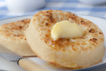 Hot Buttered Crumpets on a plate