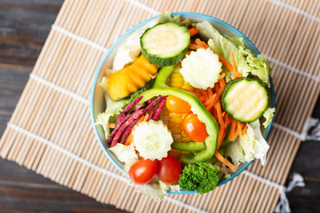 Vegetables salad in a bowl, top view of food