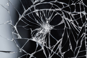 Broken glass - white lines on black background. Closeup