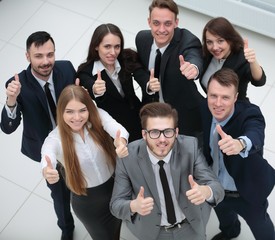 triumphant business team raised a thumbs up