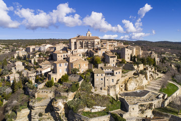 Fototapeta na wymiar Aerial view of Gordes, labelled Most Beautiful Villages of France, perched on a rocky outcrop at the end of the Vaucluse plateau, 