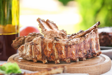 Delicious ribs served for dinner on wooden board