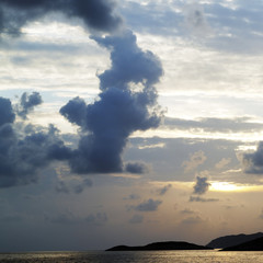 Islands in sea and sky with clouds at sunset