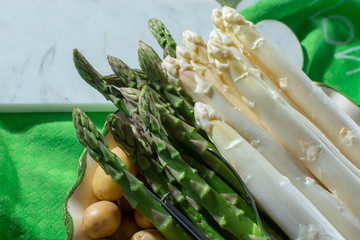 Raw uncooked fresh white and green asparagus high quality, ready to cook for dinner close up