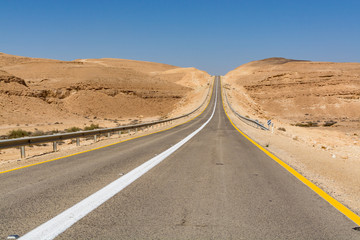 Asphalt road in desert Negev, Israel, road 40, transport infrastructure in desert, scenic mountains route from Eilat to north of Israel