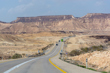Asphalt road in desert Negev, Israel, road 40, transport infrastructure in desert, scenic mountains route in Mizpe Ramon canyon in Israel