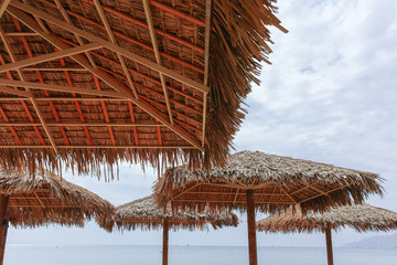 Fototapeta na wymiar Beautiful public sandy beaches on Red Sea in Eilat with stro umbrellas, luxury vacation spa resorts in Israel