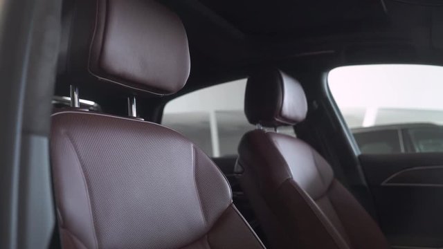 Vehicle, modern car interior, luxury car leather seats, smooth camera movement.
