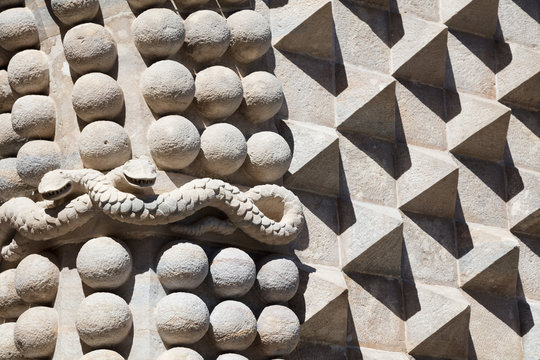 Snake and ornaments carved in stone wall at Pena Castle, Sintra