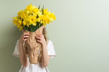 Child girl holding bouquet of yellow flowers. - Powered by Adobe