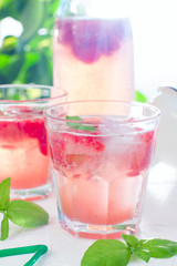 Summer refreshing drink made of strawberries and basil in glassware, summer background, selective focus