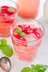 Fresh cool summer drink with strawberries and green basil, selective focus