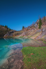 Beautiful blue mountain lake. The Blue Colour is caused by former limestone mining. (Blauer See, H&uuml;ttenrode near Blankenburg, National Park Harz in Germany