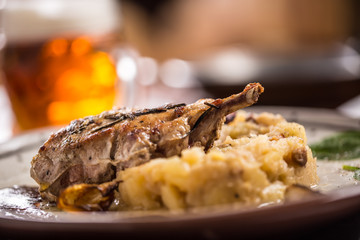 Iberian cutlet with mashes potatoes decoration and draft beere in pub or restaurant