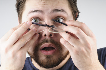 Shocked man with broken glasses on his face - 201174209