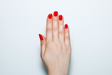 Female hand with red nails painted on a white background - 201175685
