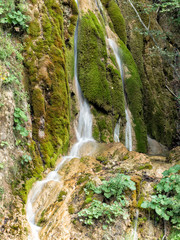 Beautiful landscape of a waterfall with green moss, Alba, Romania