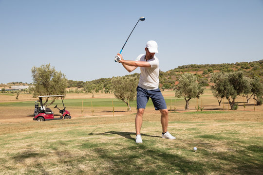 Golfer hitting a golf shot in the course