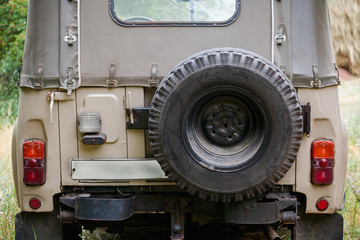 Old SUV close-up with spare wheel, back view