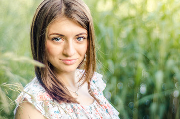 fashionable young healthy woman smiling  in stylish trendy dress on the background of nature