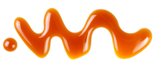 Sweet caramel sauce isolated on white background, top view. Flowing caramel.