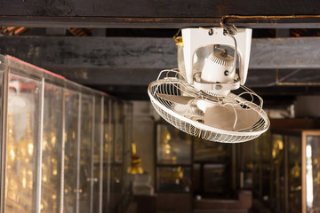White fan on ceiling in temple.Thailand.