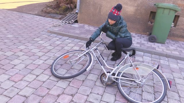 Woman near bicycle in yard