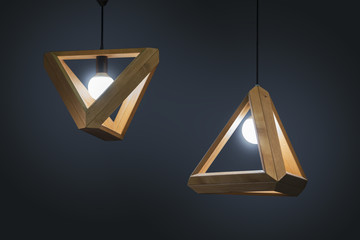 Beautiful wooden geometric modern ceiling lamp interior contemporary decoration isolated on a dark...