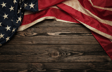 Fototapeta premium Old USA flag on wooden background with copy space