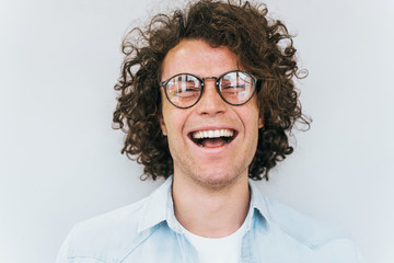 Closeup studio shot of handsome freckled positive smiling male posing for social advertisement,...