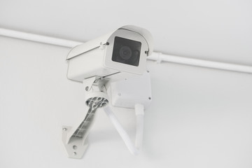 CCTV security camera installed on the building wall, operating indoor and outdoor, surveillance system.