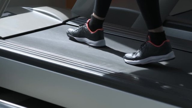 Sporty woman doing a treadmill workout