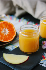 Glass filled by fresh mango and orange juice.