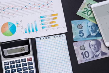 Obraz premium Business analyze, canadian dollar, graph and calculator