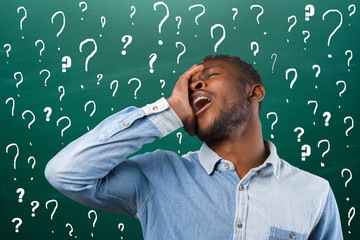 Puzzled thoughtful african american man, student, businessman solving his problem