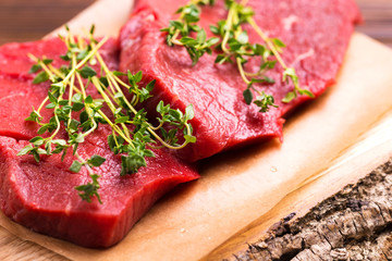 Fresh raw beef tenderloin and marbled steaks with seasoning