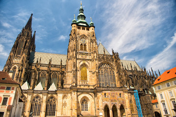 Fototapeta na wymiar Church building in prague, czech republic. St.vitus cathedral on cloudy blue sky. Monument of gothic architecture and design. Vacation and wanderlust concept