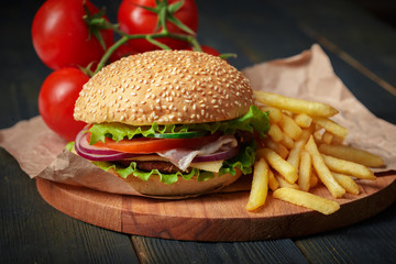 Fast food, homemade burger on a wooden background