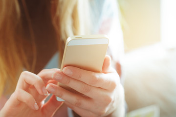 Woman typing write message on smart phone
