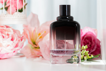 Fototapeta na wymiar Perfume bottles with flowers