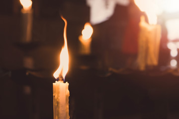 The candle was lit on the altar.Vintage tone.
