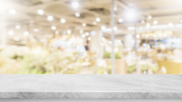 Empty marble stone table top on blurred with bokeh shopping mall background - can be used for display or montage your products