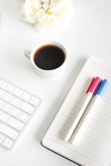 White office desk with a cap of coffee