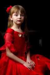 Fototapeta premium Little girl on a black background