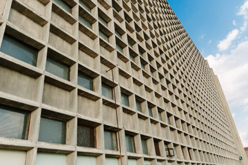 Gray stone modern facade of a building with windows